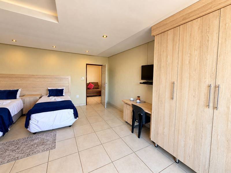 Lion twin room with two single beds and a large wardrobe